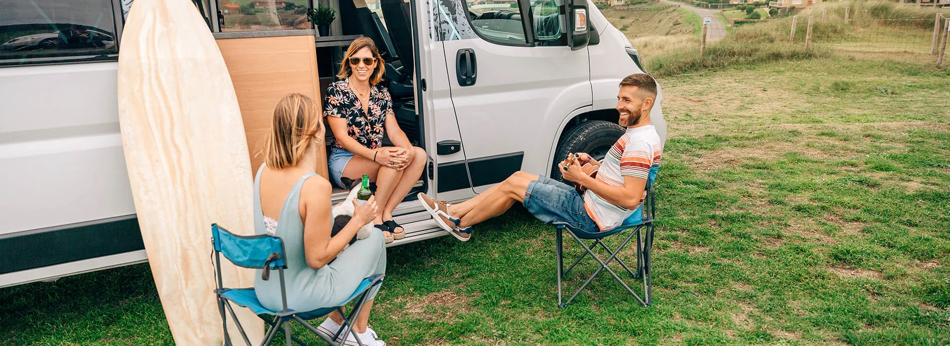 friends relaxing outside their camper 